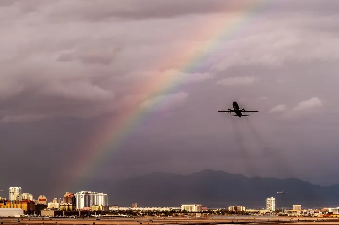 Airplane takeoff with rainbow