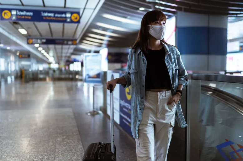 Woman in airport wearing mask