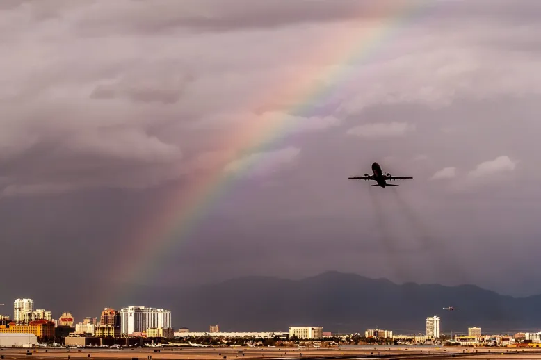 Airplane takeoff with rainbow