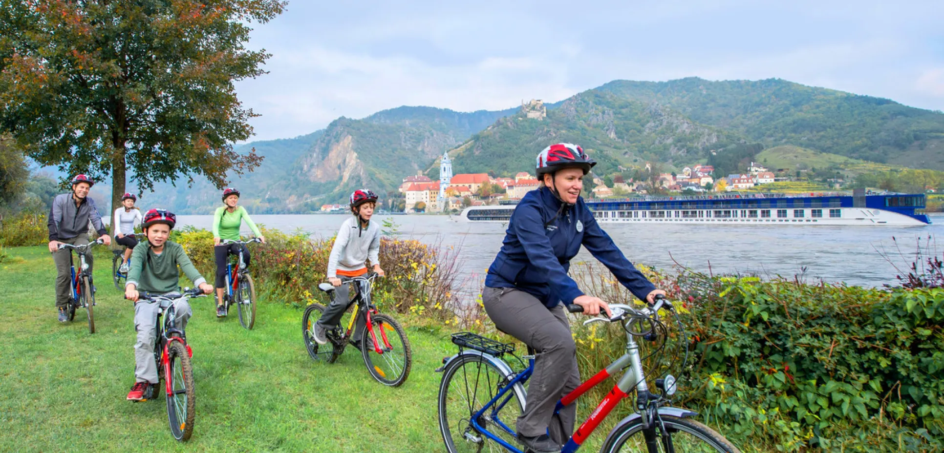 Adventures by disney europe danube river cruise itinerary hero 01 biking next to the danube river1