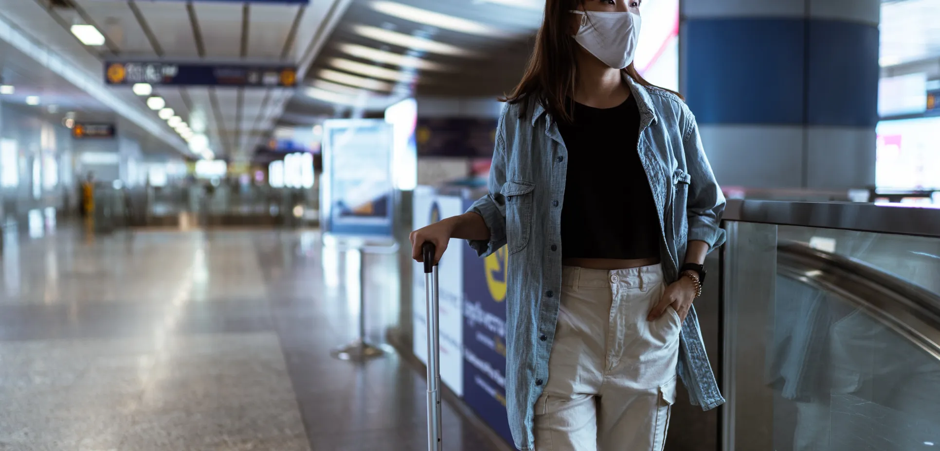 Woman in airport wearing mask