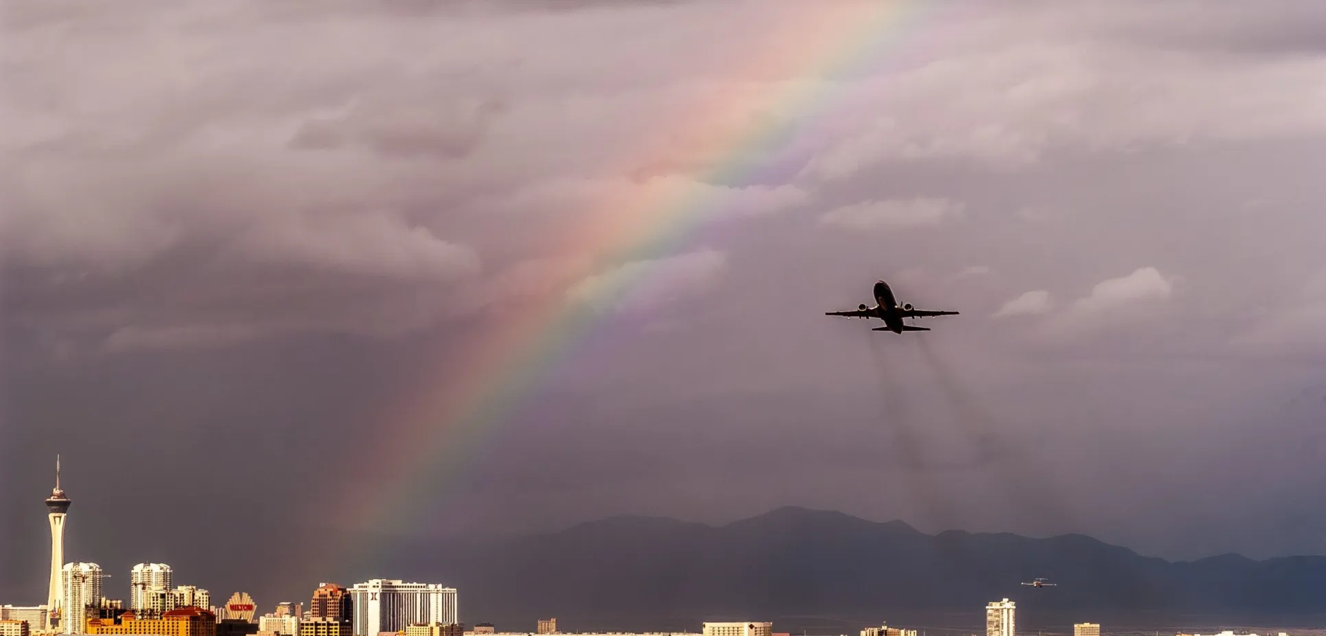 Airplane takeoff with rainbow