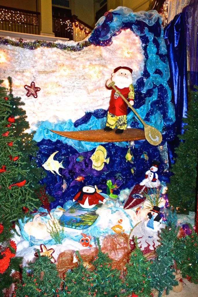 Santa stand up paddling in the barrel of a wave